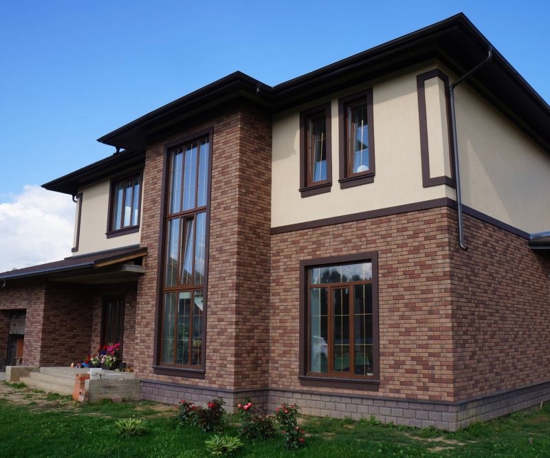 House cladding with panels under a brick