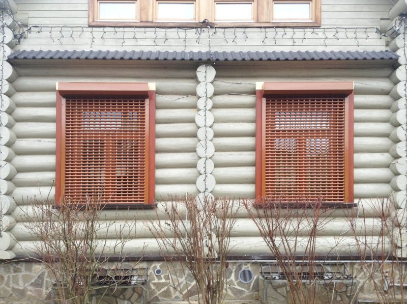 Roller shutters on the windows external for the summer cottage