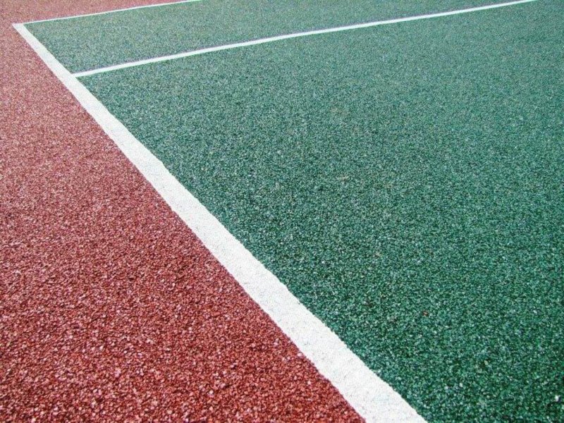 Rubber coating for sports grounds