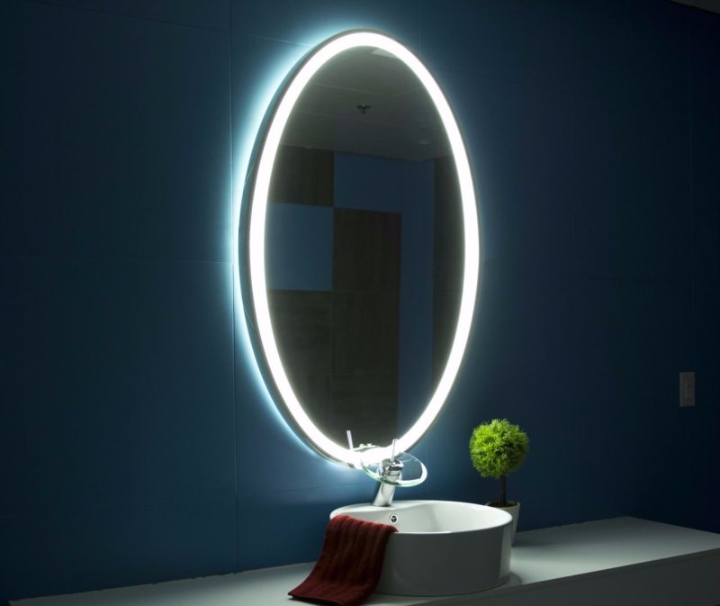 Oval mirror with backlight in the bathroom