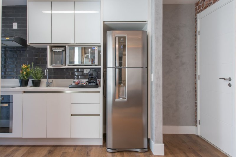 A kitchen with a separate refrigerator