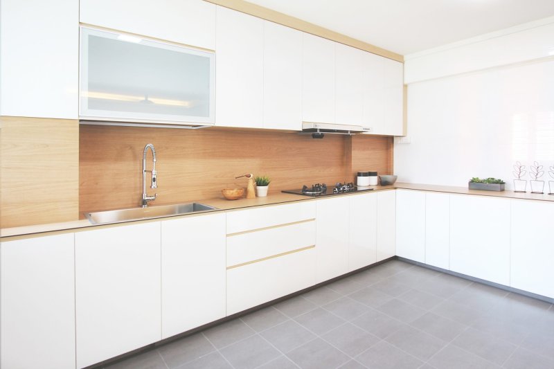 White glossy kitchen with a wooden countertop