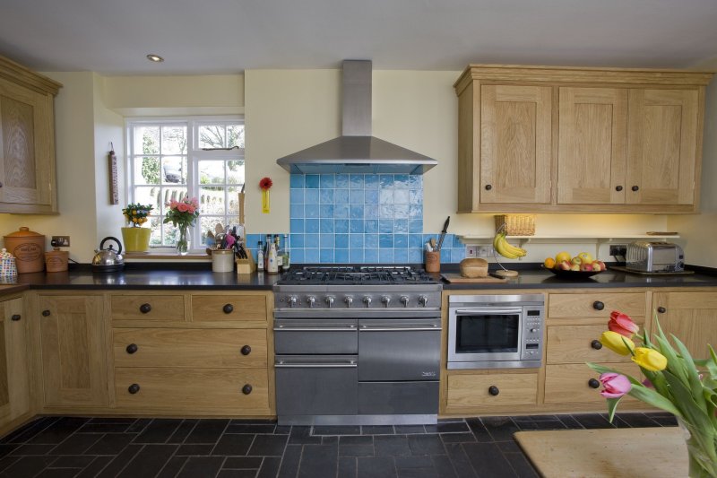 Blue kitchen with a tabletop under a tree