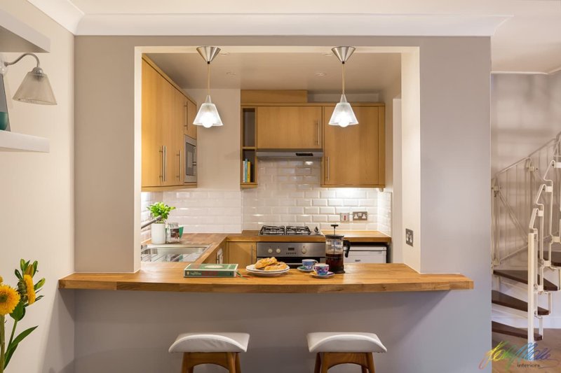 Kitchen with a bar along the wall