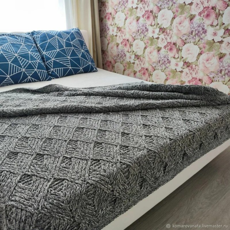 Knitted bedspread on the bed