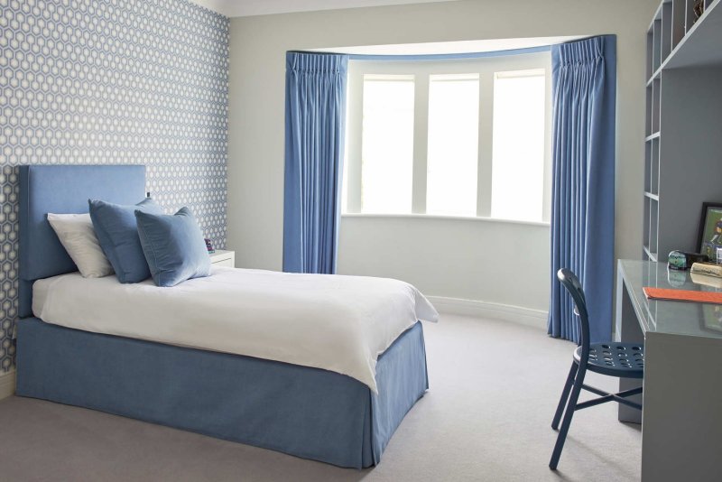 Blue curtains in the interior of the bedroom