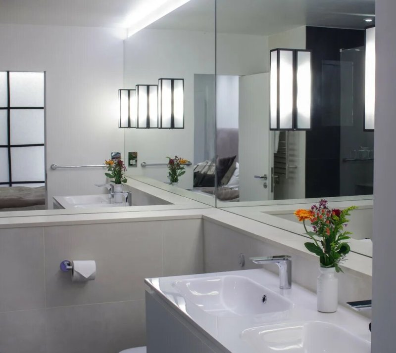 A bathroom with a large mirror