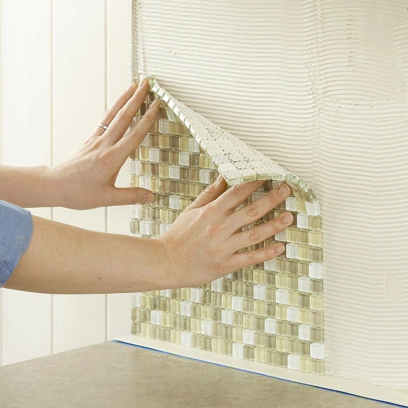 Laying mosaic on the wall