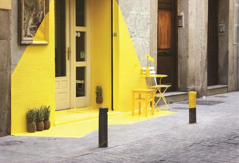 The yellow facade of the house