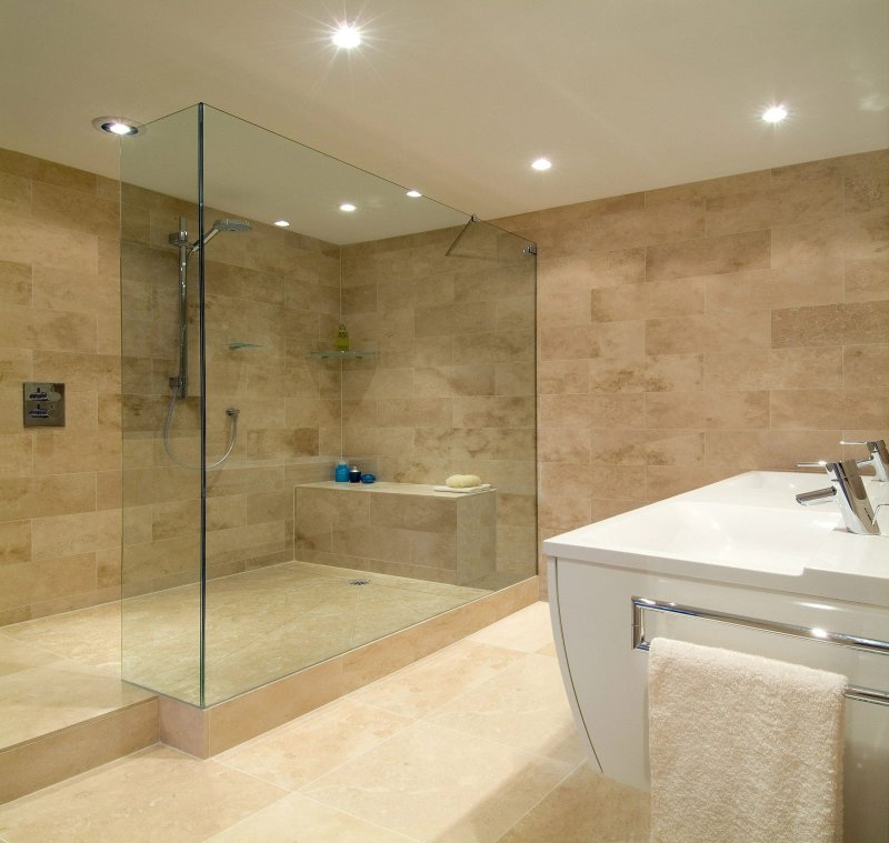 Bath with a shower partition of glass design