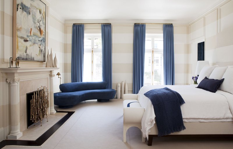 Blue curtains in the interior of the bedroom