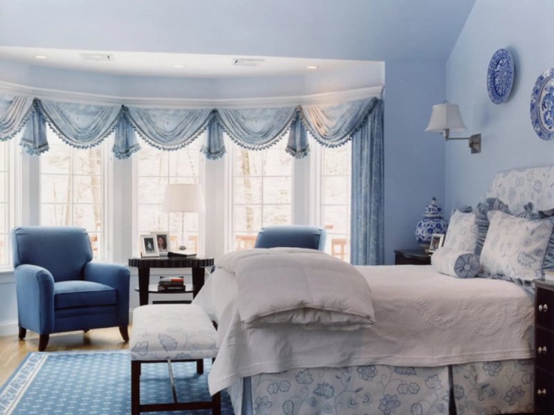 Blue curtains in the interior of the bedroom