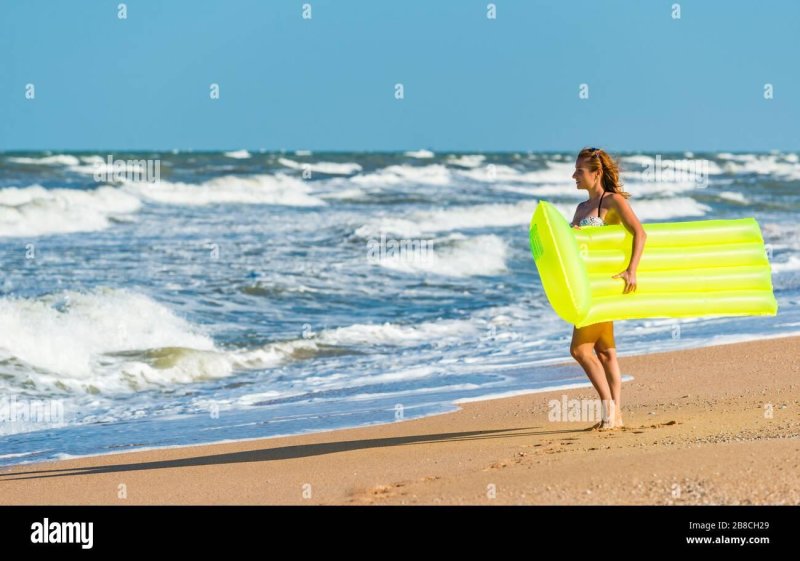 Girl on an inflatable mattress at sea