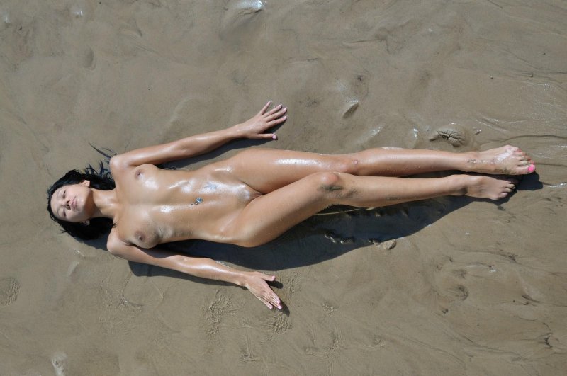 Naked girls on the beach in sand