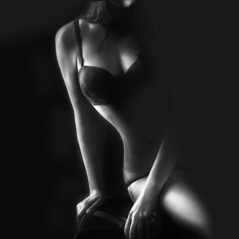 Naked woman on a black background
