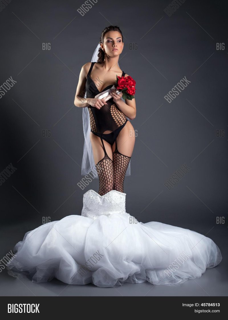 In a corset and stockings