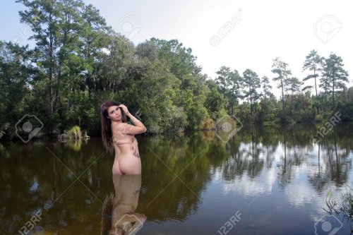 Naked women bathe in the river