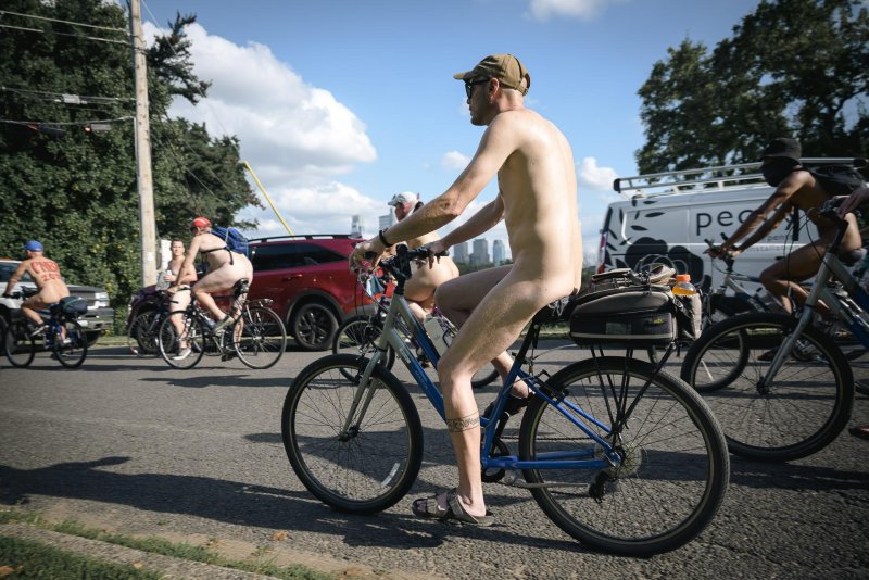 Guy naked on a bicycle