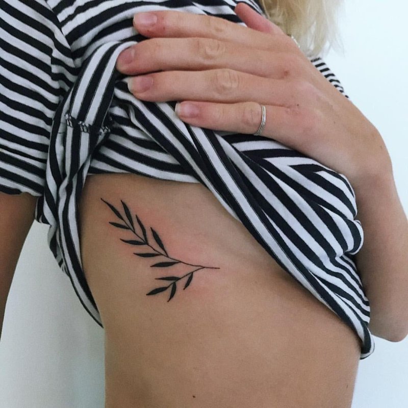 Tattoo twigs under the chest