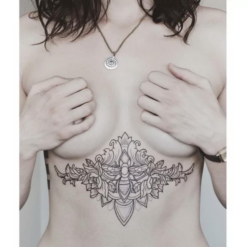 Female tattoo under the chest