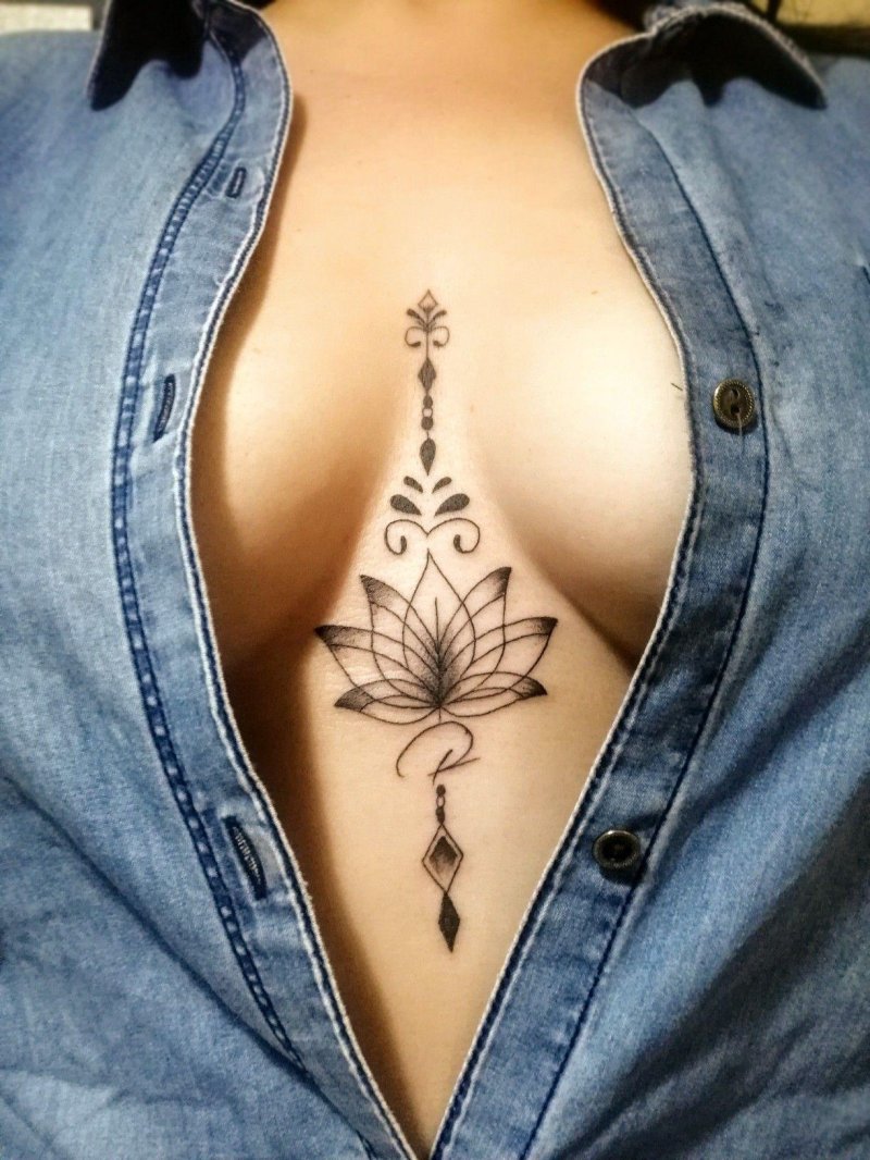 Lotus tattoo between the sternum
