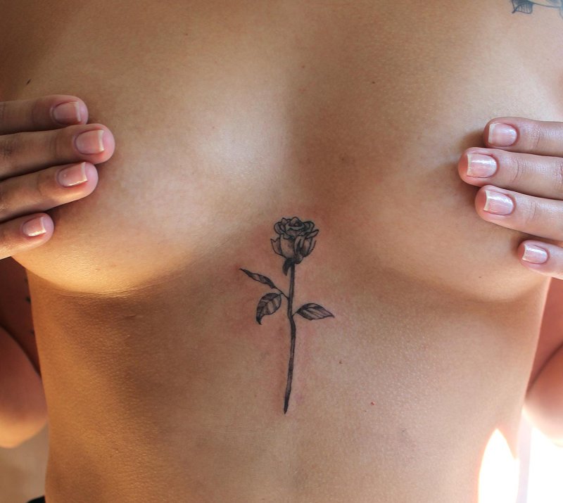Rose tattoo between breasts