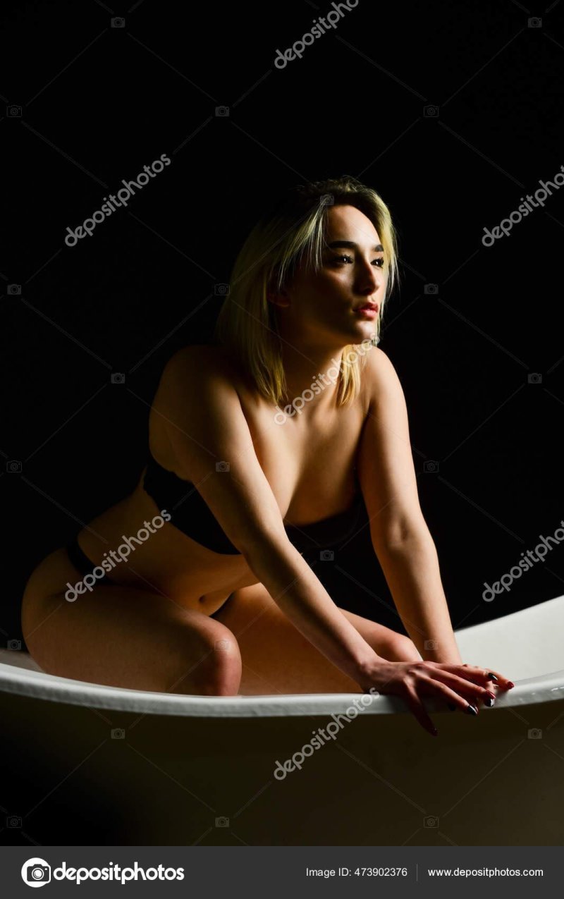 Woman sits in the bathroom