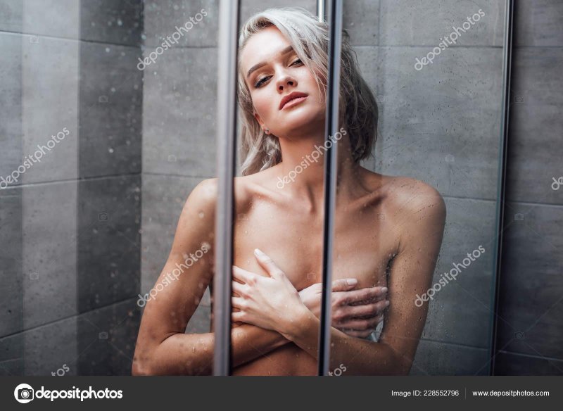 The girl washes under shower