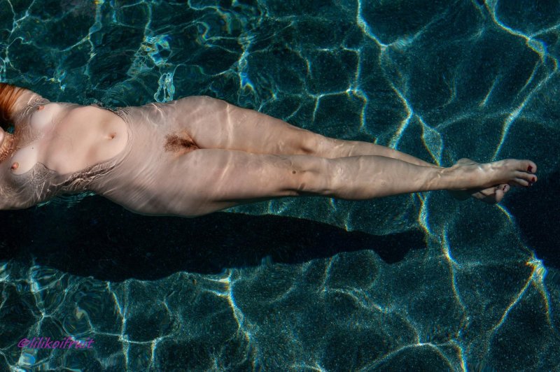 Naked female body in water