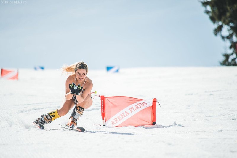 Girl in a swimsuit on snowboarding